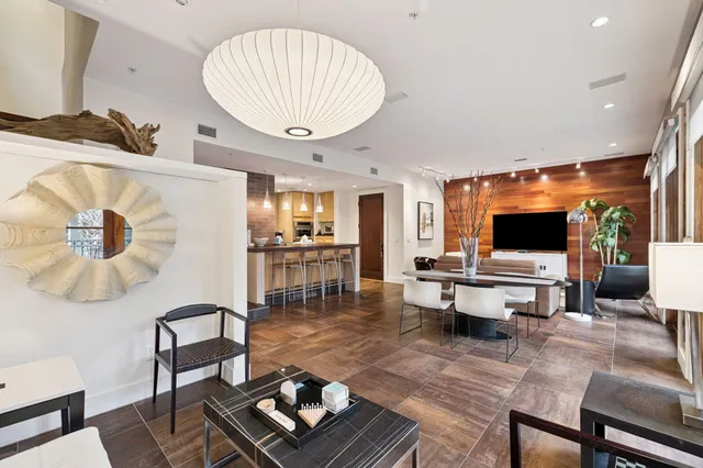 a kitchen with stainless steel appliances granite countertop a sink and a refrigerator