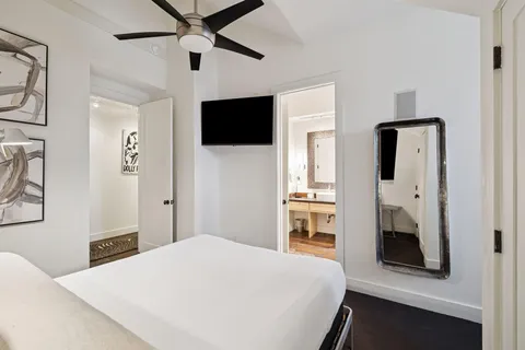 a bedroom with a bed and a flat screen tv