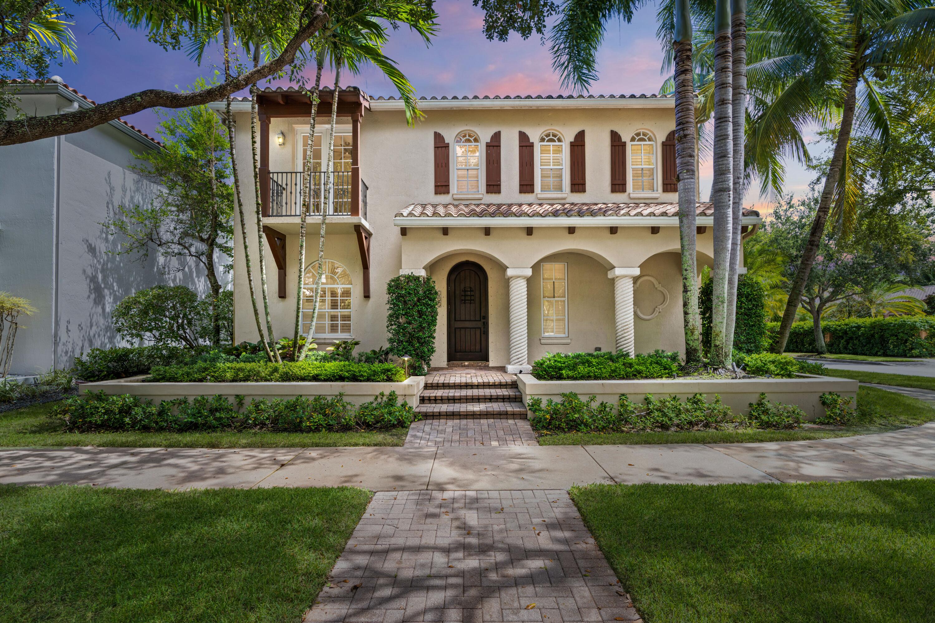 a front view of a house with a garden