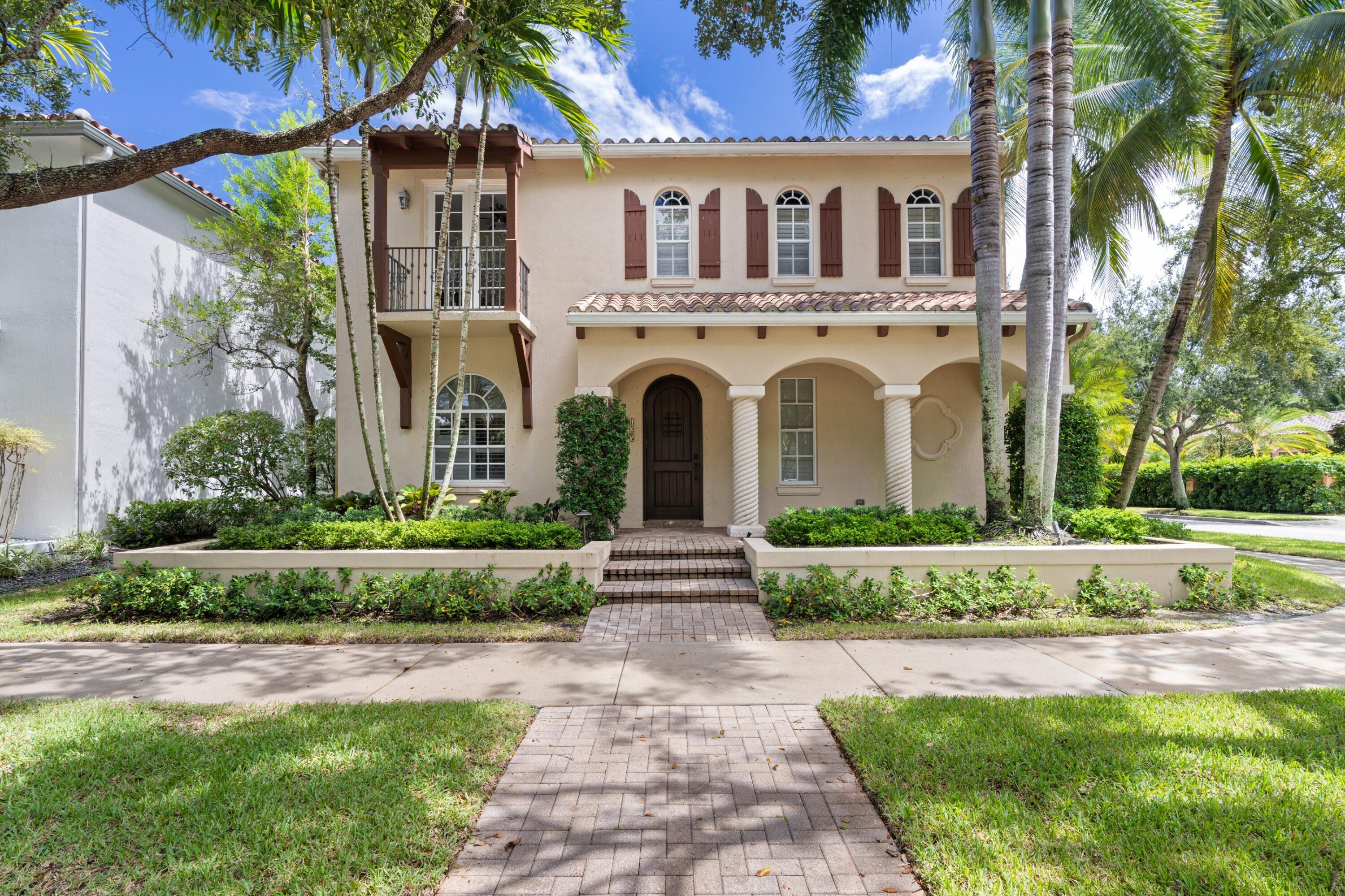125 Bilboa Drive Jupiter, FL 33458 - Photo 3 of 5 a front view of a house with garden