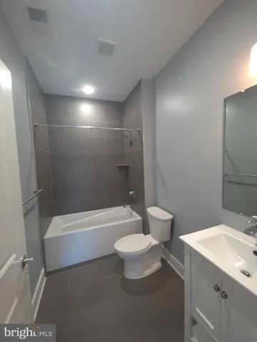 a bathroom with a toilet a sink and bathtub