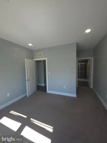 a kitchen with refrigerator and chairs