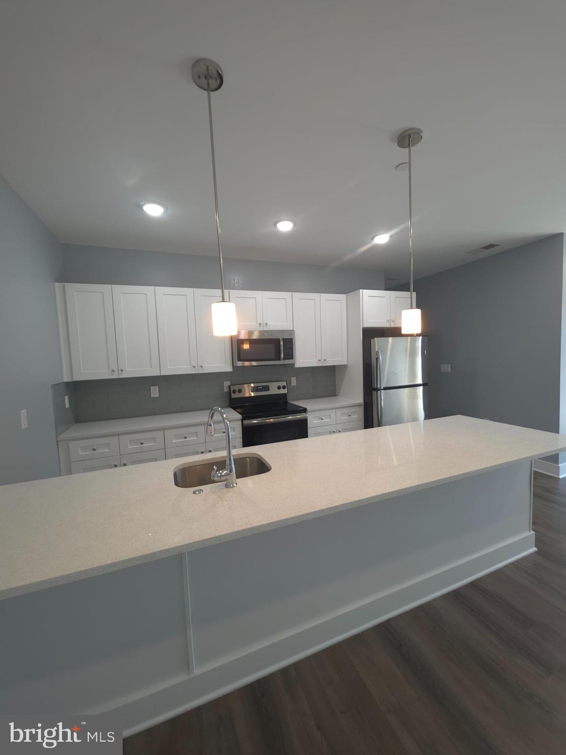 3925-29 Haverford Avenue, Unit 302 Philadelphia, PA 19104 - Photo 33 of 40 a kitchen with refrigerator and chairs