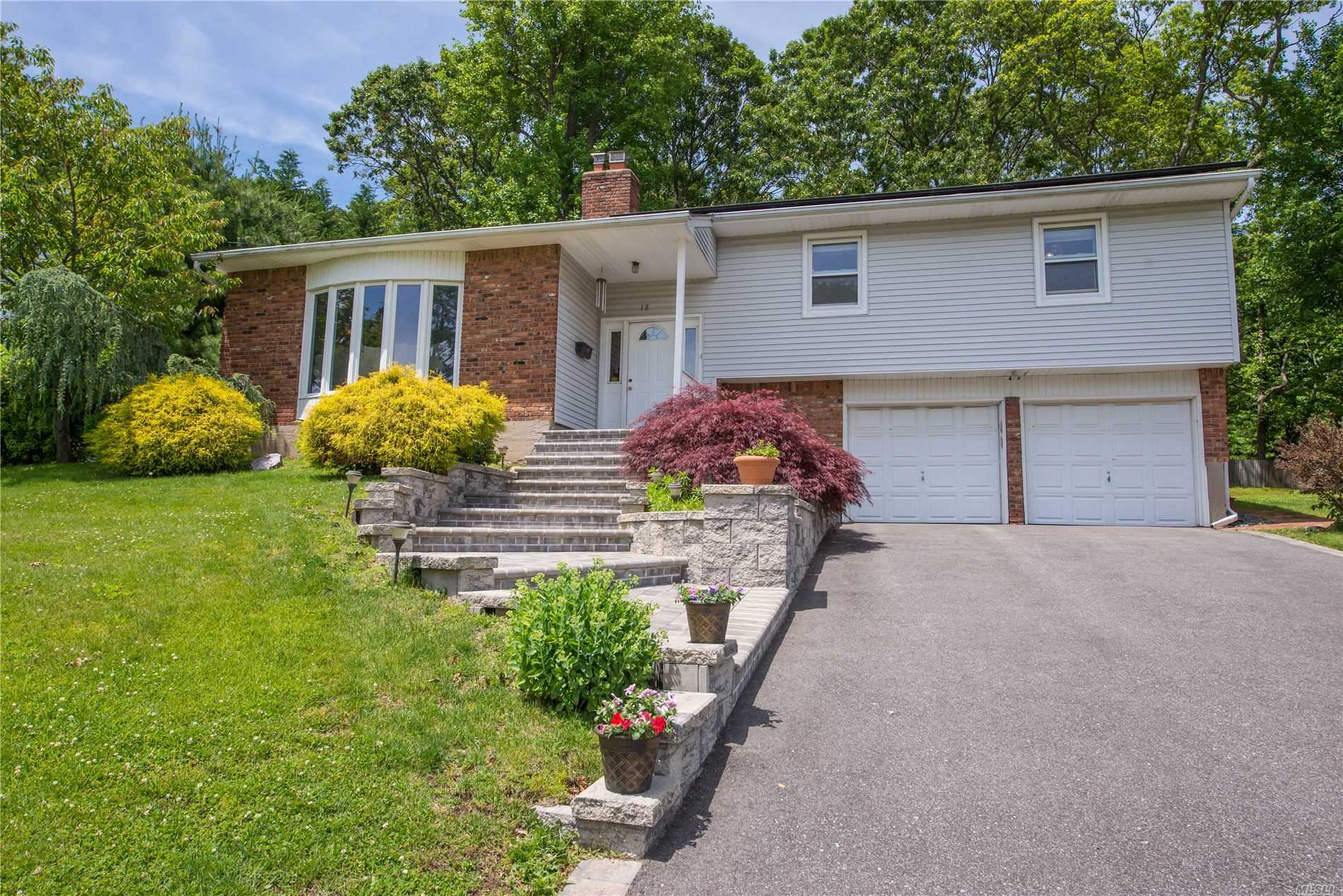 18 Long Ridge Road Plainview, NY 11803 - Photo 1 of 1 a front view of house with yard and outdoor seating