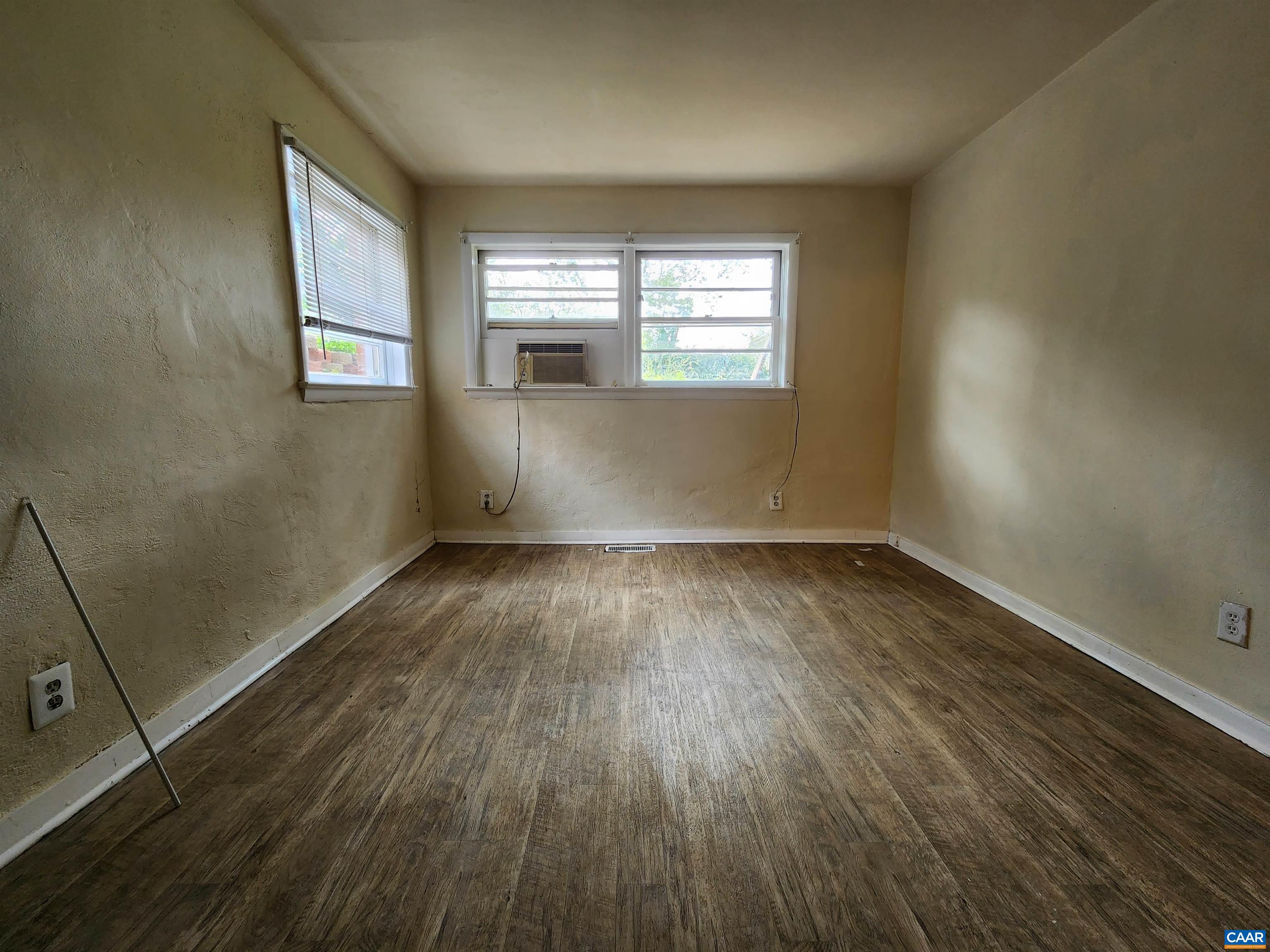 130 Apple Tree Road, Unit C Charlottesville, VA 22903 - Photo 11 of 11 an empty room with wooden floor and windows
