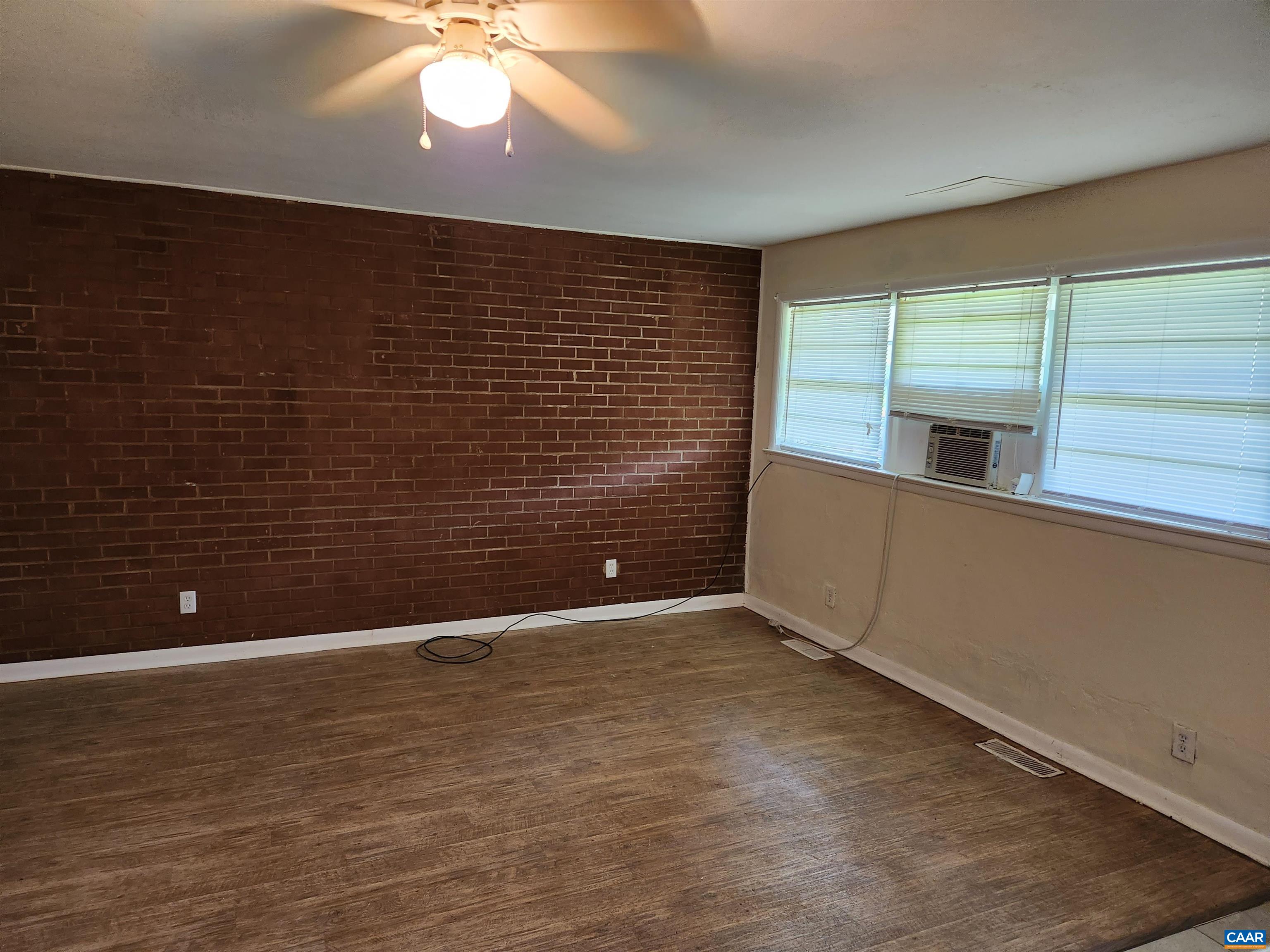 130 Apple Tree Road, Unit C Charlottesville, VA 22903 - Photo 4 of 11 a view of an empty room with window and wooden floor