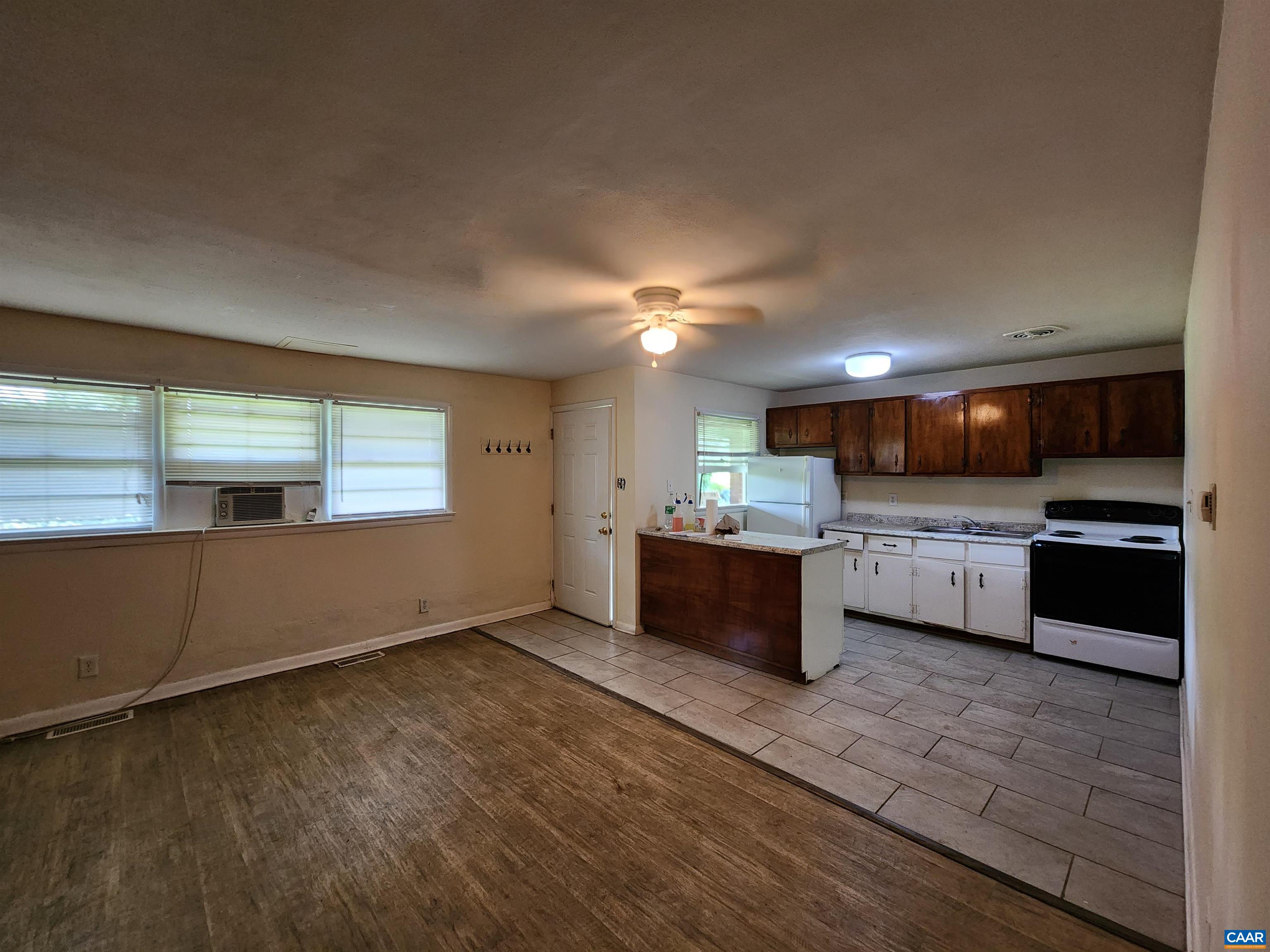 130 Apple Tree Road, Unit C Charlottesville, VA 22903 - Photo 6 of 11 a kitchen with stainless steel appliances kitchen island granite countertop a stove a sink and a refrigerator