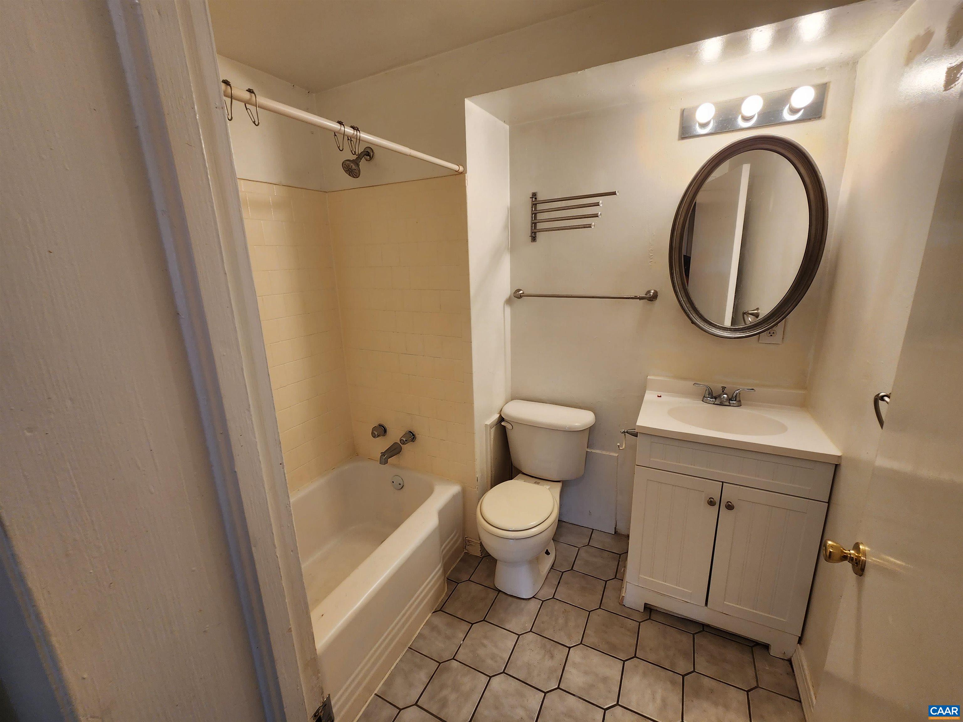 130 Apple Tree Road, Unit C Charlottesville, VA 22903 - Photo 9 of 11 a bathroom with a sink a toilet and a mirror