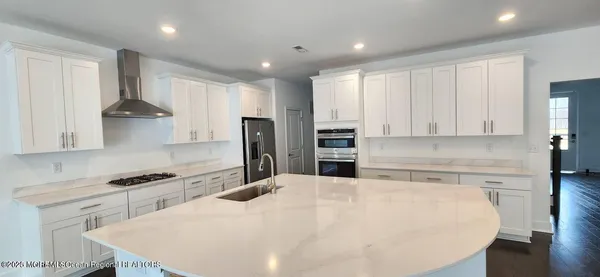 a kitchen with stainless steel appliances a refrigerator sink and cabinets