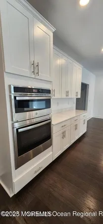 a kitchen with stainless steel appliances a stove a microwave and sink