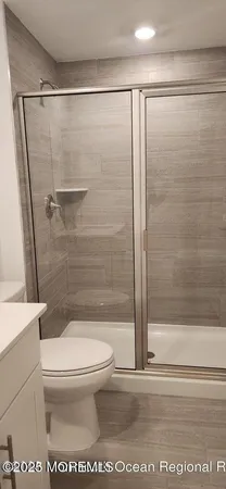 a bathroom with a shower and a toilet