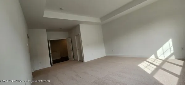 an empty room with windows and entrance
