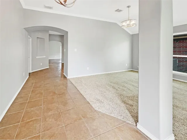 an empty room with white walls and tiles