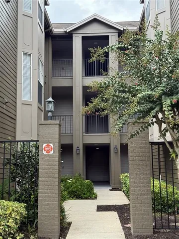 a front view of a house with glass windows and yard