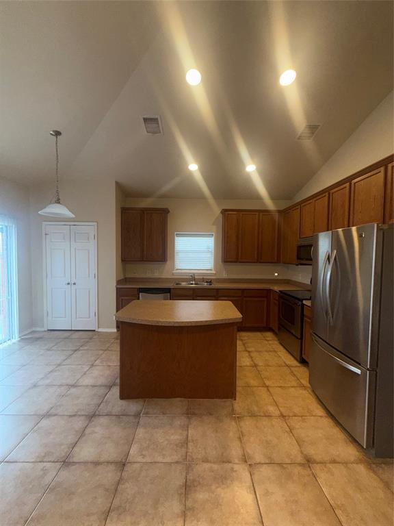 6506 Portside Ridge Lane Dallas, TX 75249 - Photo 12 of 23 a kitchen with stainless steel appliances granite countertop a refrigerator and a stove