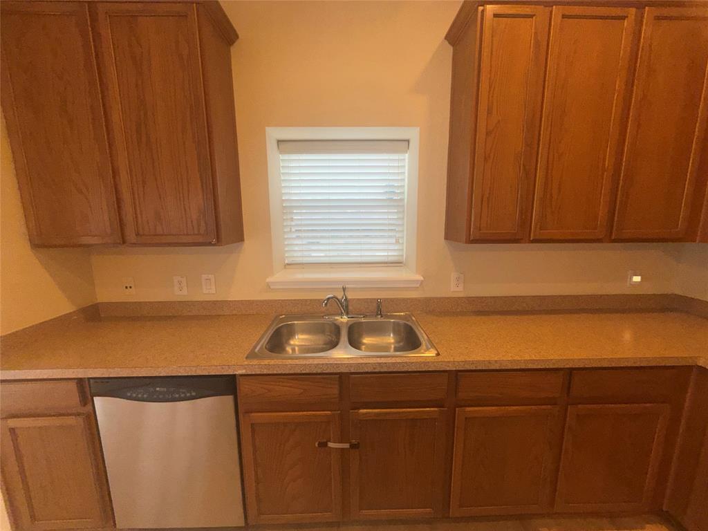 6506 Portside Ridge Lane Dallas, TX 75249 - Photo 16 of 23 a kitchen with a sink and cabinets