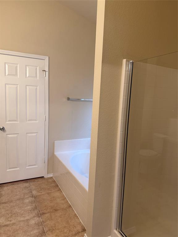 6506 Portside Ridge Lane Dallas, TX 75249 - Photo 21 of 23 a bathroom with a tub and shower