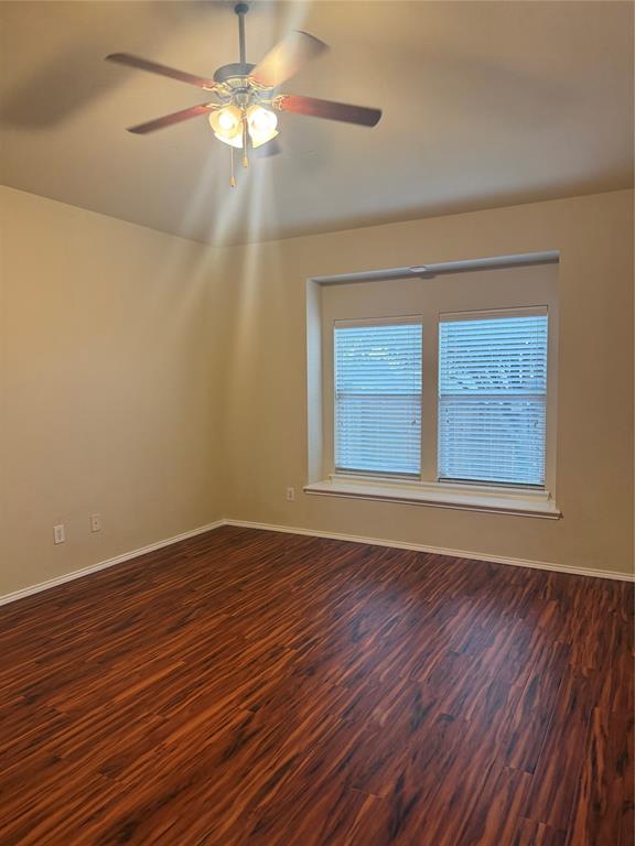 6506 Portside Ridge Lane Dallas, TX 75249 - Photo 22 of 23 a view of an empty room with wooden floor and a window