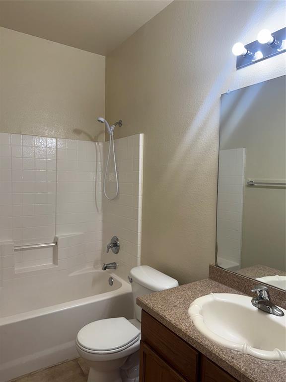 6506 Portside Ridge Lane Dallas, TX 75249 - Photo 7 of 23 a bathroom with a granite countertop toilet a sink and a bathtub