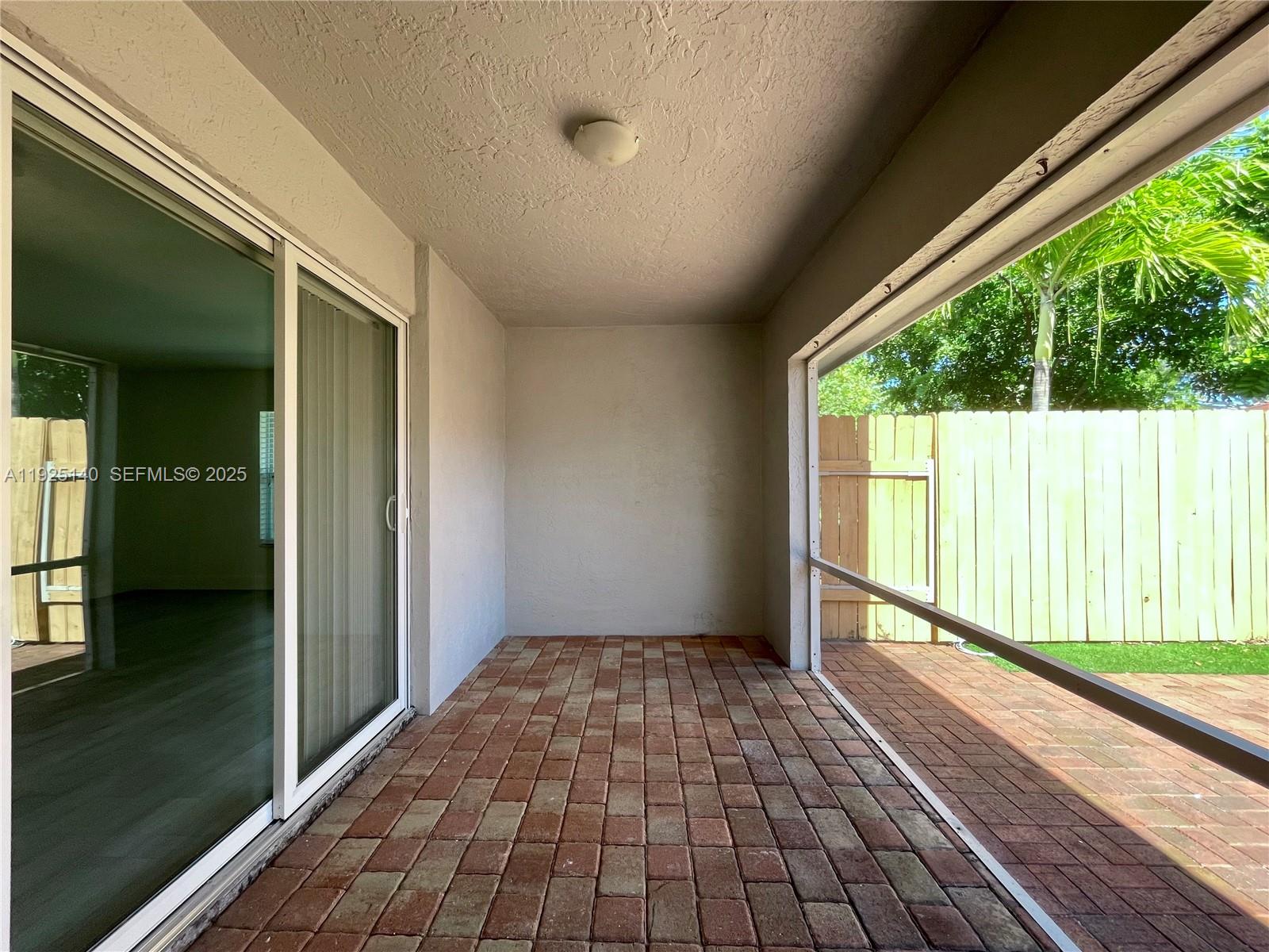 2230 Spanish Trail, Unit A Delray Beach, FL 33483 - Photo 18 of 23 a view of empty room with wooden floor and outdoor view
