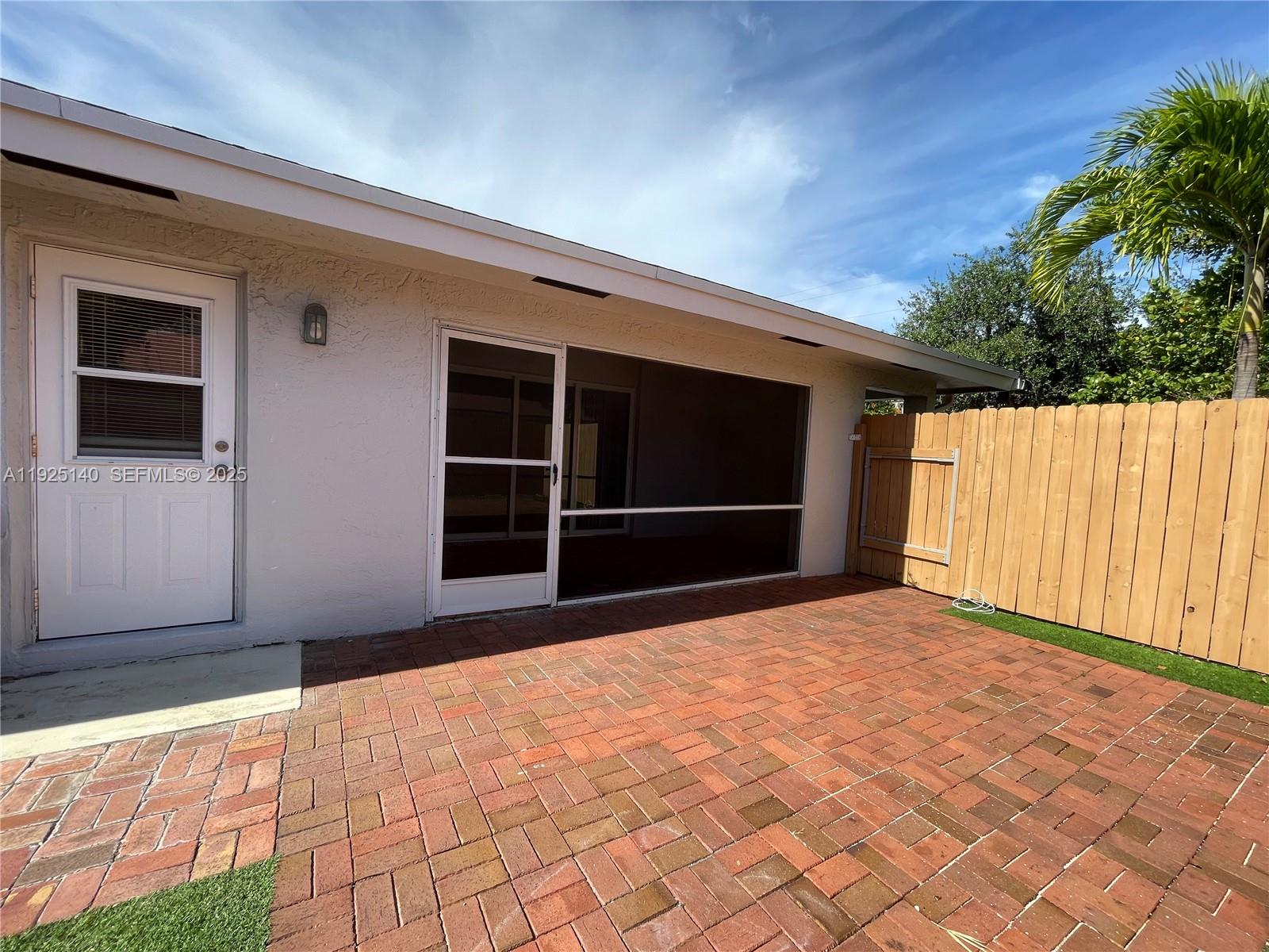 2230 Spanish Trail, Unit A Delray Beach, FL 33483 - Photo 20 of 23 a view of an empty room with a window and wooden walls