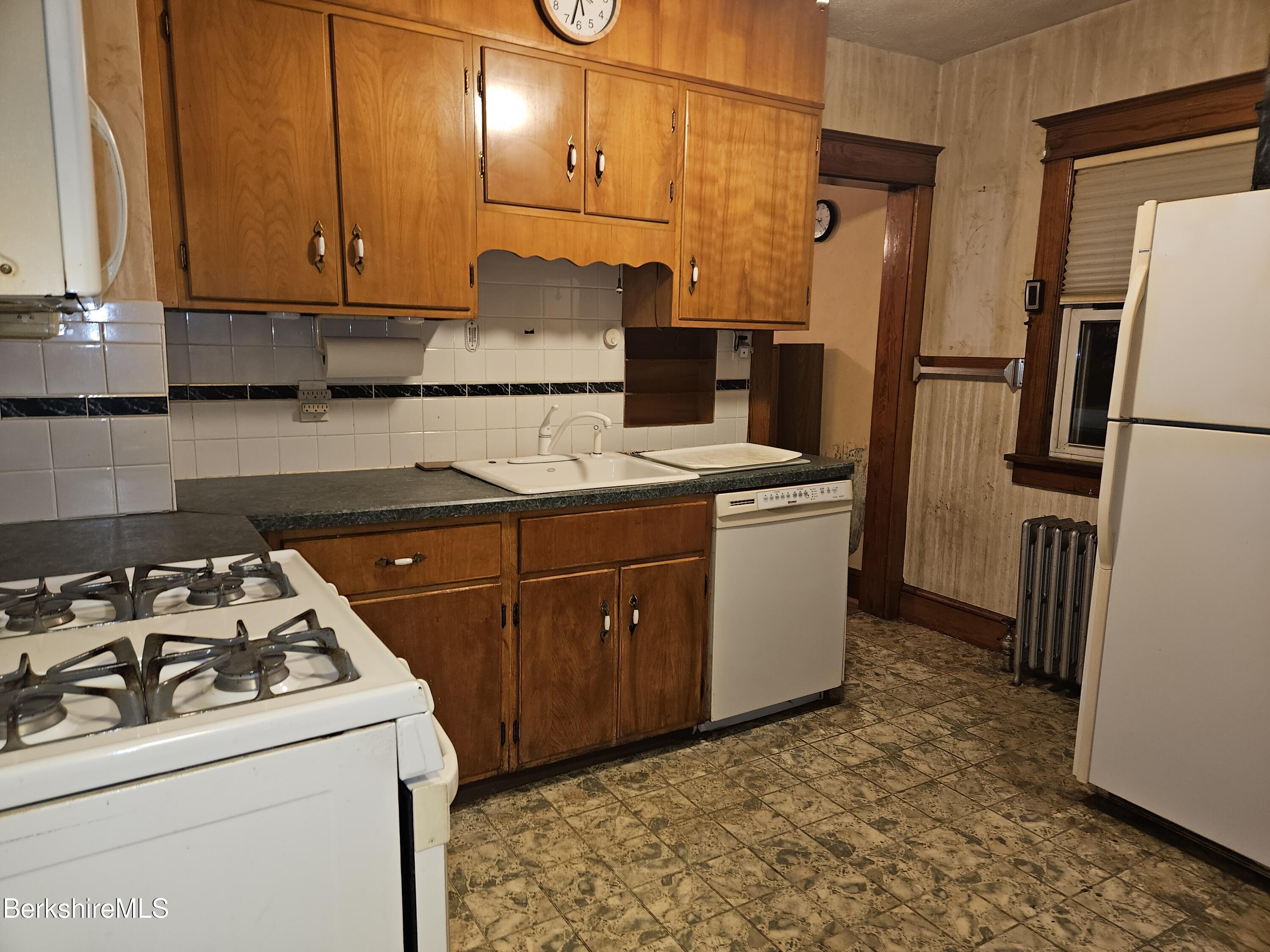 269 2nd Street Pittsfield, MA 01201 - Photo 18 of 39 a kitchen with a refrigerator sink stove and cabinets