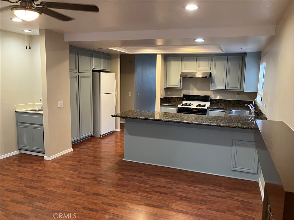 19933 Ralph Street Walnut, CA 91789 - Photo 35 of 77 a kitchen with wooden floors and refrigerator