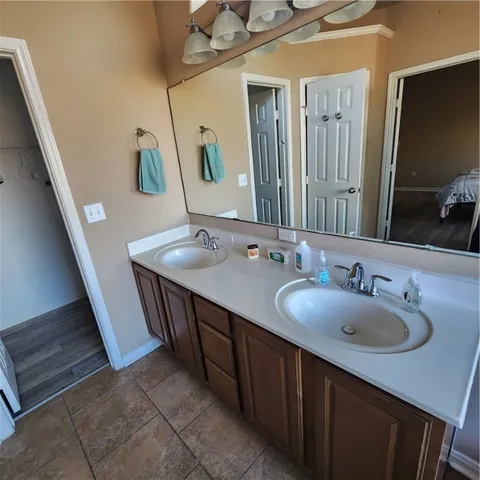 a bathroom with a double vanity sink and a mirror