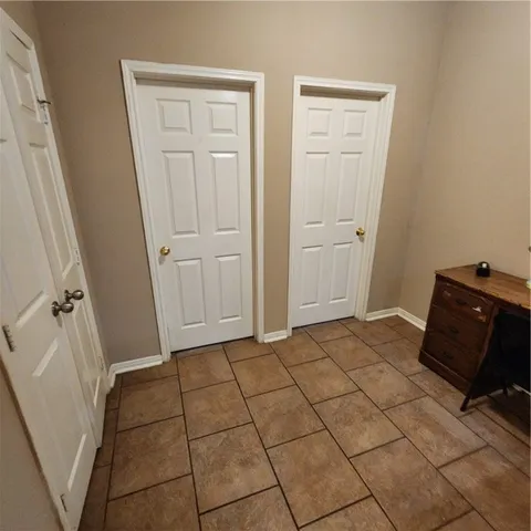 a view of a closet area with rug and a window