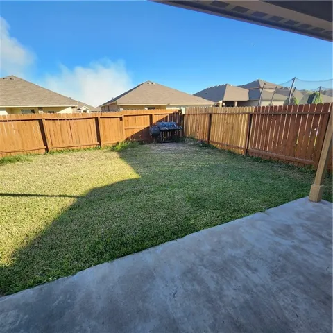 a view of a backyard with a garden and deck