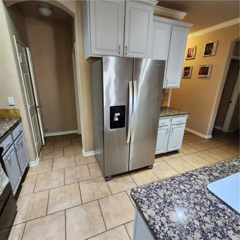 a refrigerator freezer sitting inside of a kitchen