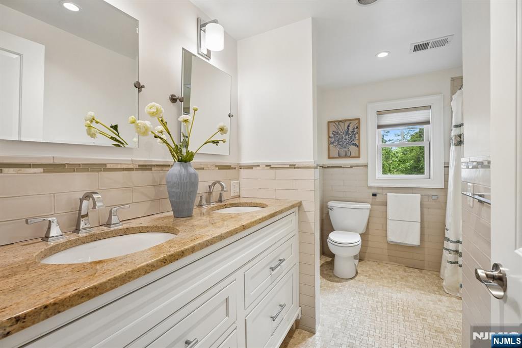 11 Mt Vernon Road Montclair, NJ 07043 - Photo 31 of 49 a bathroom with a granite countertop sink a toilet and mirror