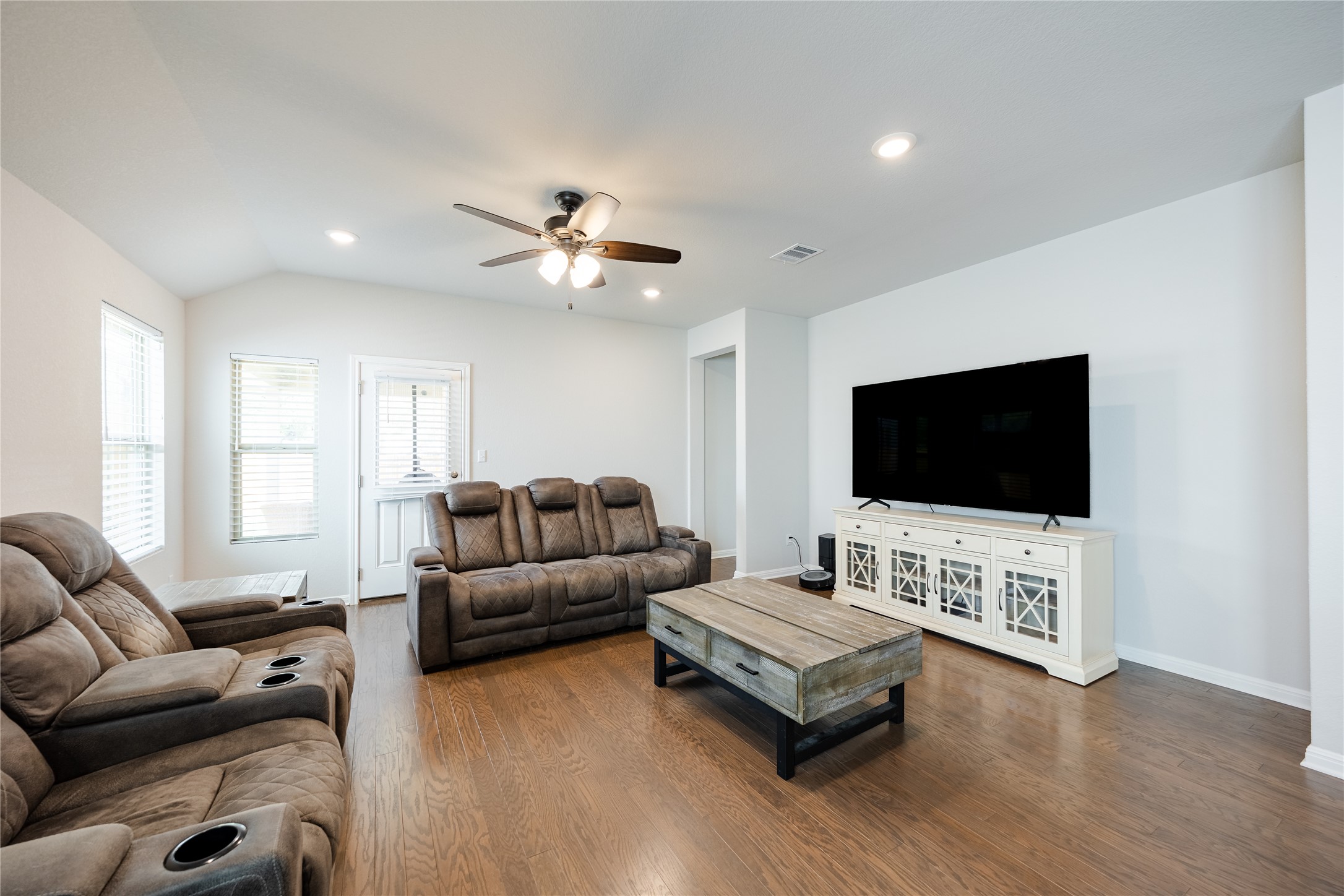 2021 Cartway Court Leander, TX 78641 - Photo 9 of 31 Living room featuring visible vents, a ceiling fan, wood finished floors, and lofted ceiling
