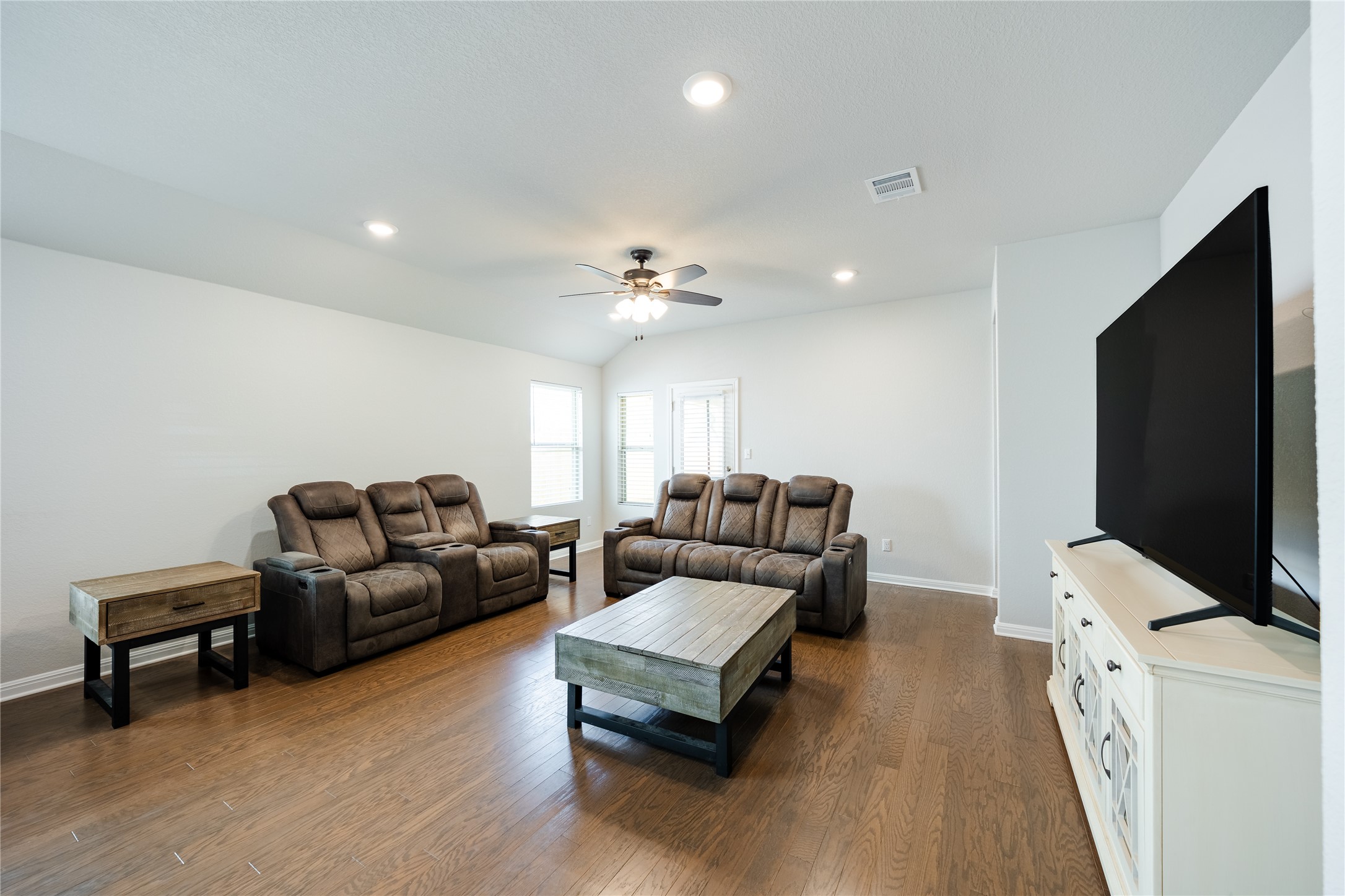 2021 Cartway Court Leander, TX 78641 - Photo 12 of 31 Living room with visible vents, ceiling fan, baseboards, and dark wood-style floors