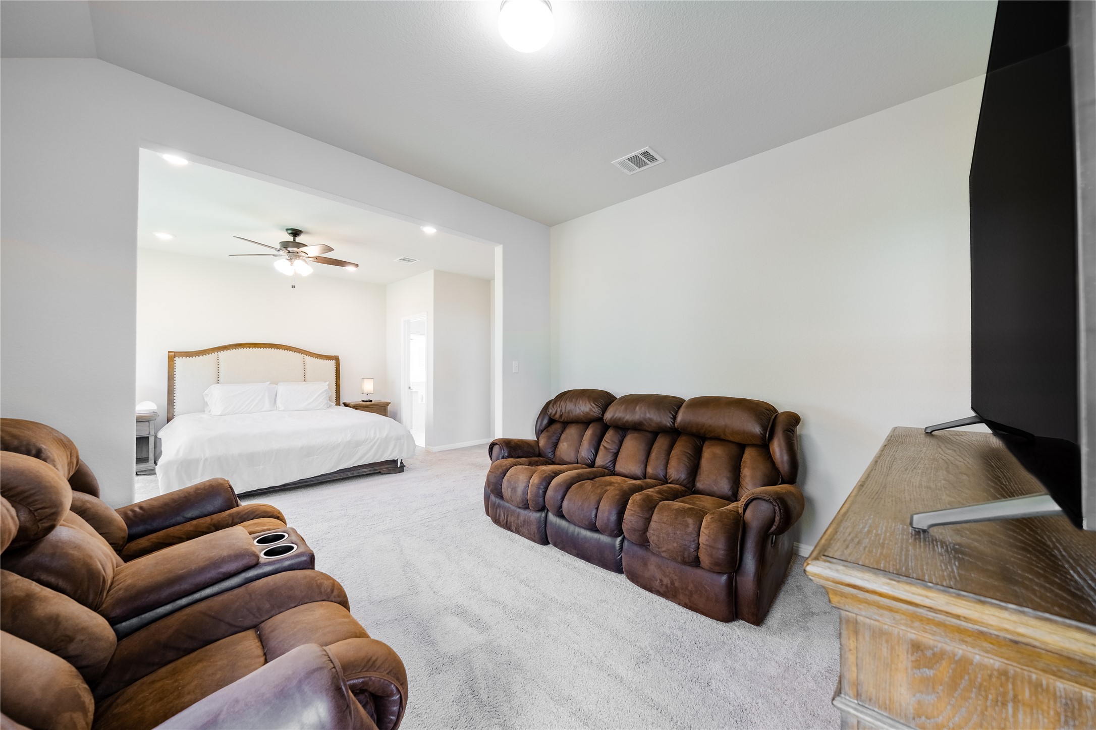 2021 Cartway Court Leander, TX 78641 - Photo 16 of 31 Bedroom with carpet flooring, visible vents, vaulted ceiling, and ceiling fan