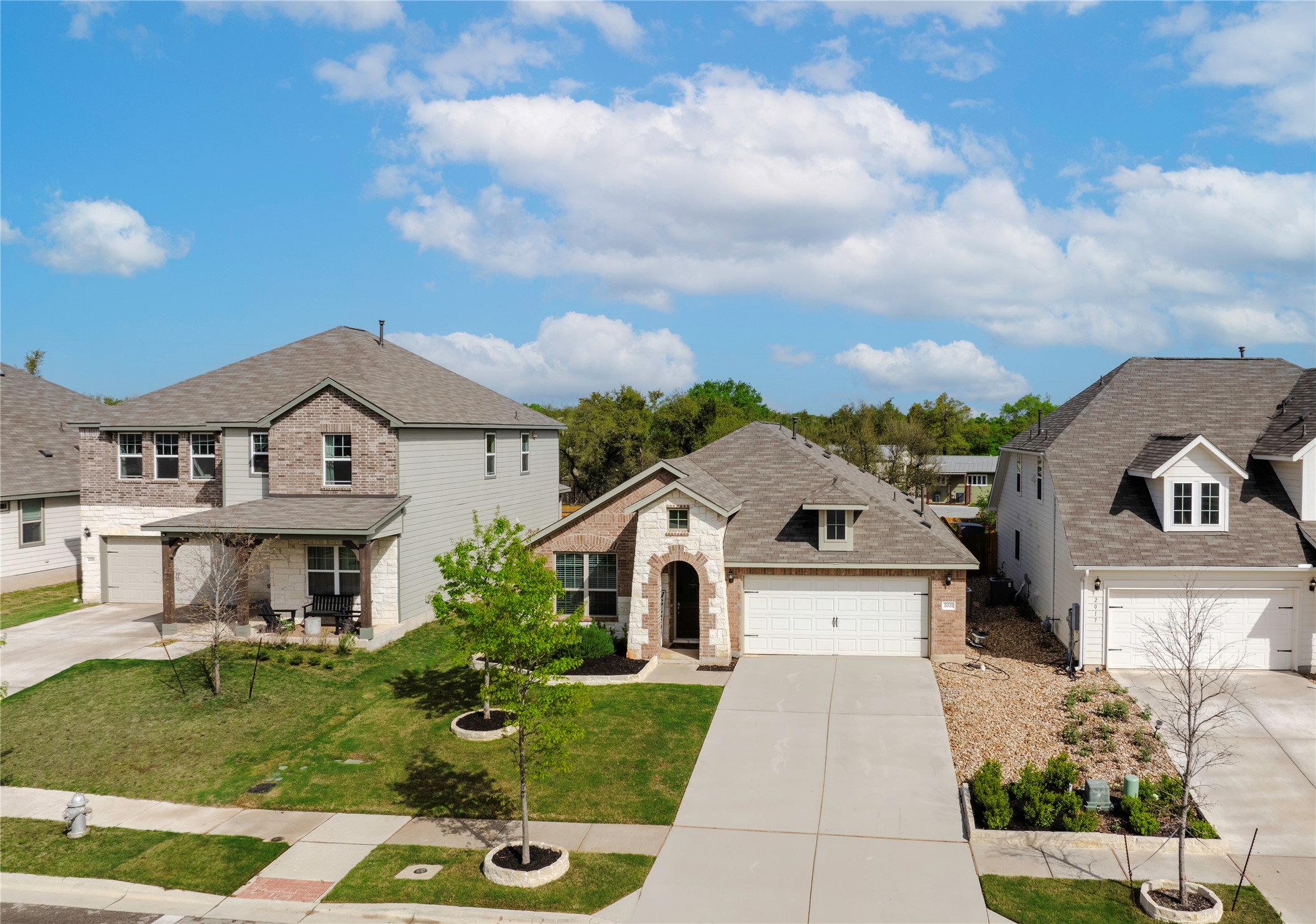 2021 Cartway Court Leander, TX 78641 - Photo 2 of 31 View of front of home with a garage, a front yard, brick siding, and driveway