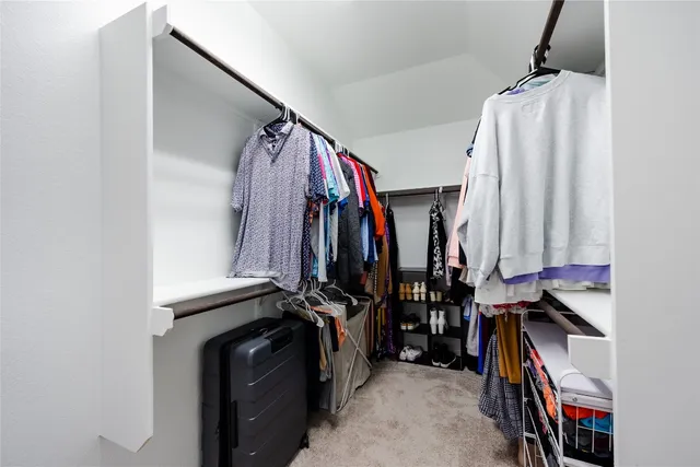 a spacious bathroom with a shower sink and mirror