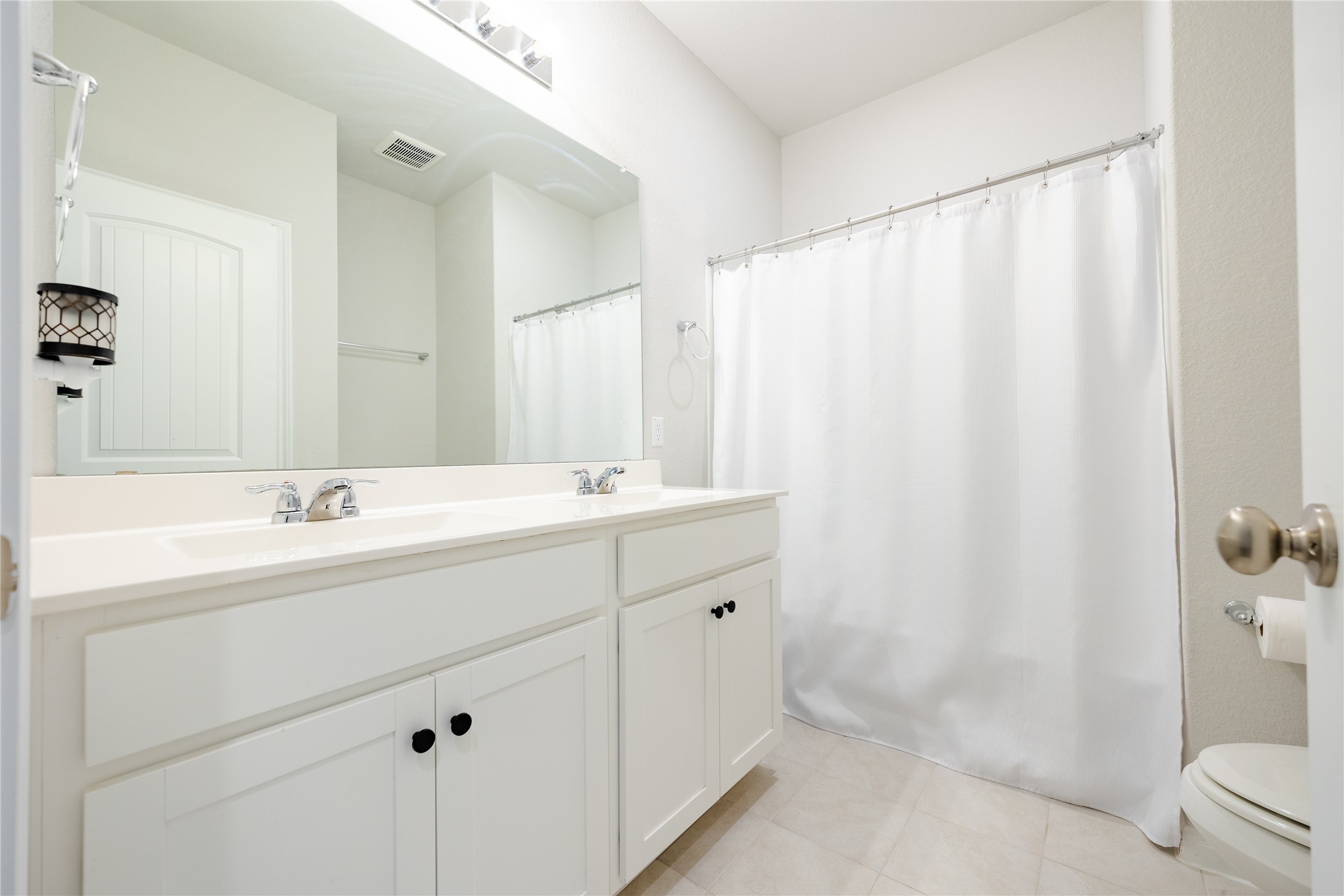 2021 Cartway Court Leander, TX 78641 - Photo 22 of 31 Full bath featuring visible vents, a sink, toilet, double vanity, and tile patterned floors
