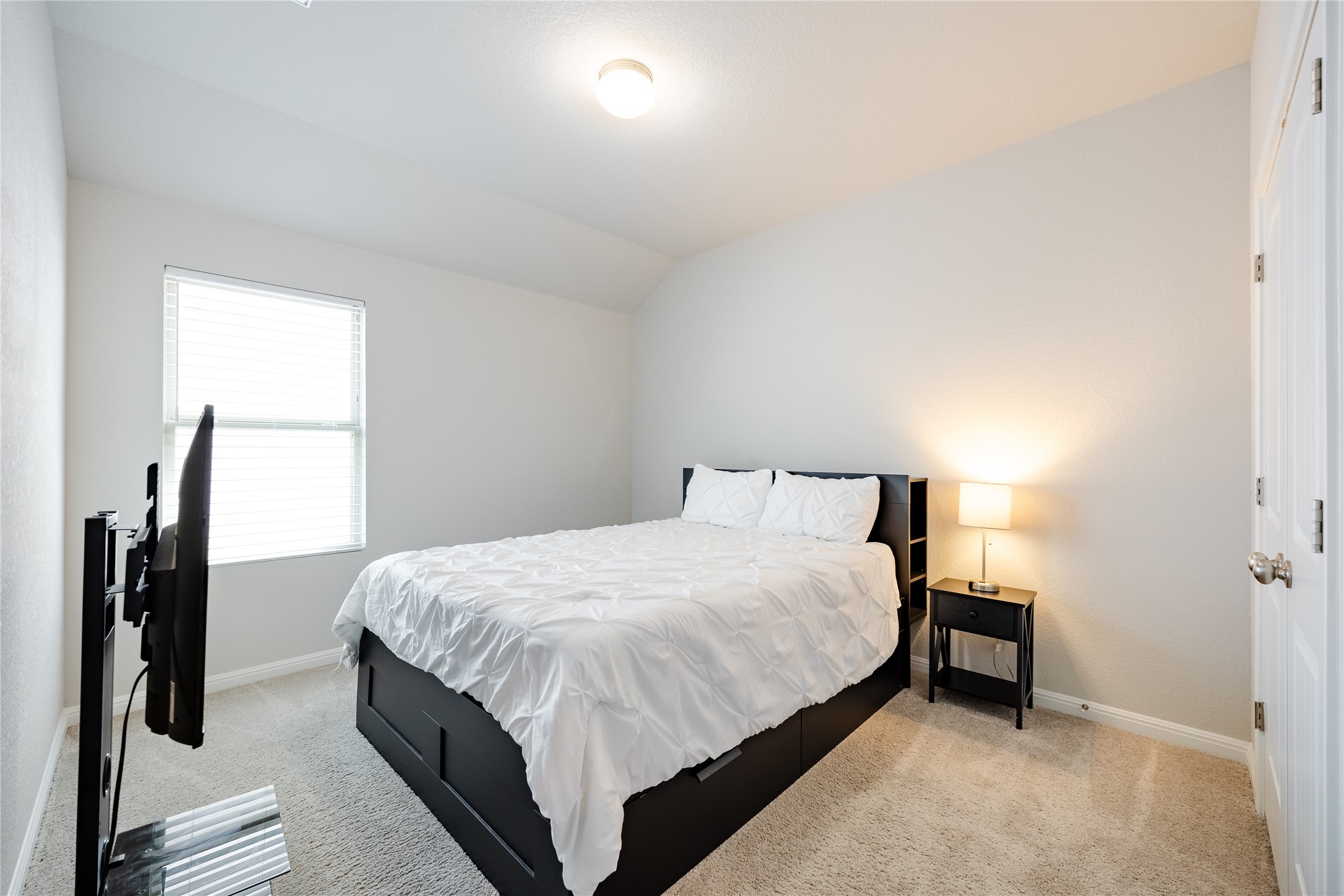 2021 Cartway Court Leander, TX 78641 - Photo 23 of 31 Bedroom featuring baseboards, vaulted ceiling, and light carpet