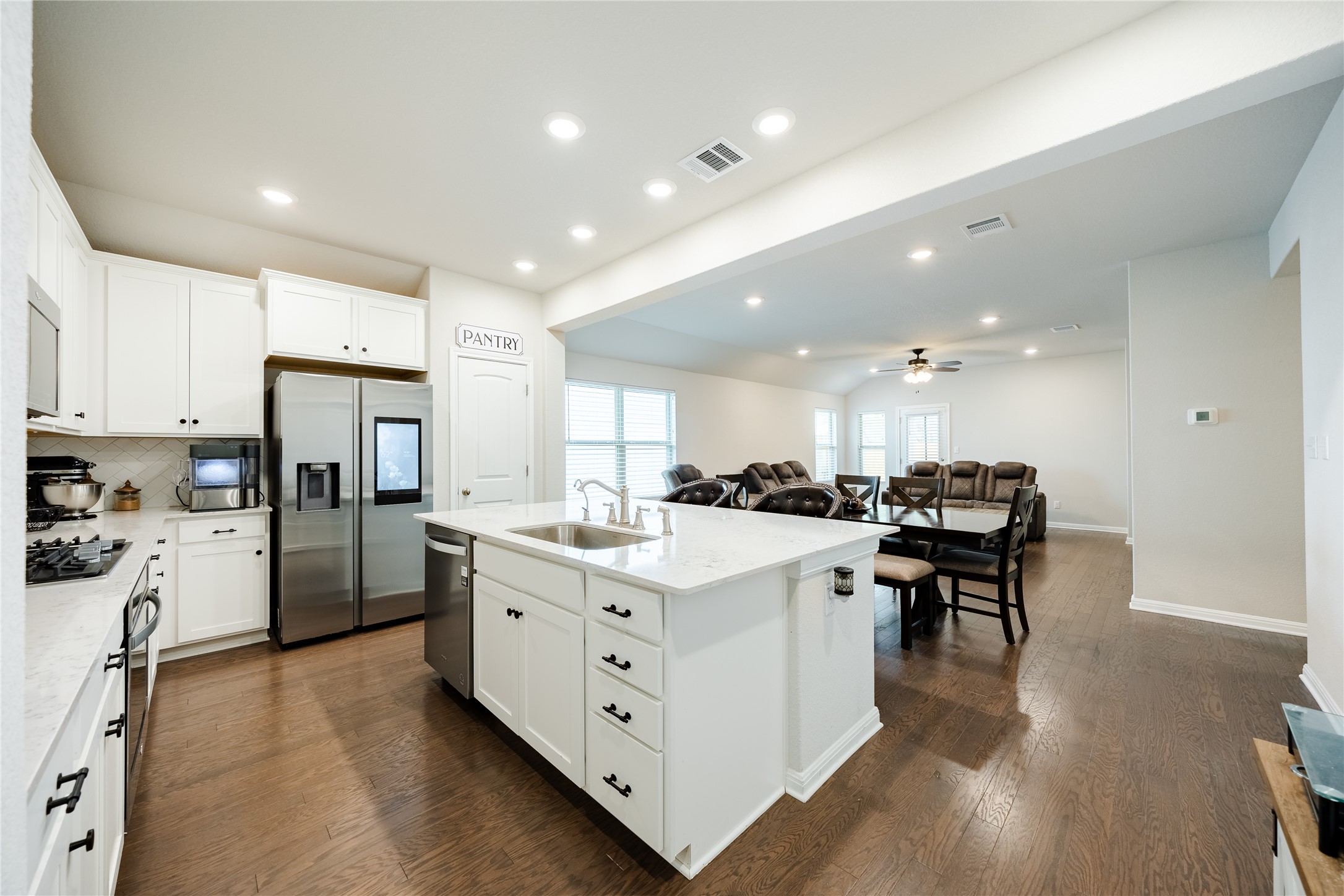 2021 Cartway Court Leander, TX 78641 - Photo 30 of 31 Kitchen featuring a ceiling fan, visible vents, a sink, stainless steel appliances, and open floor plan