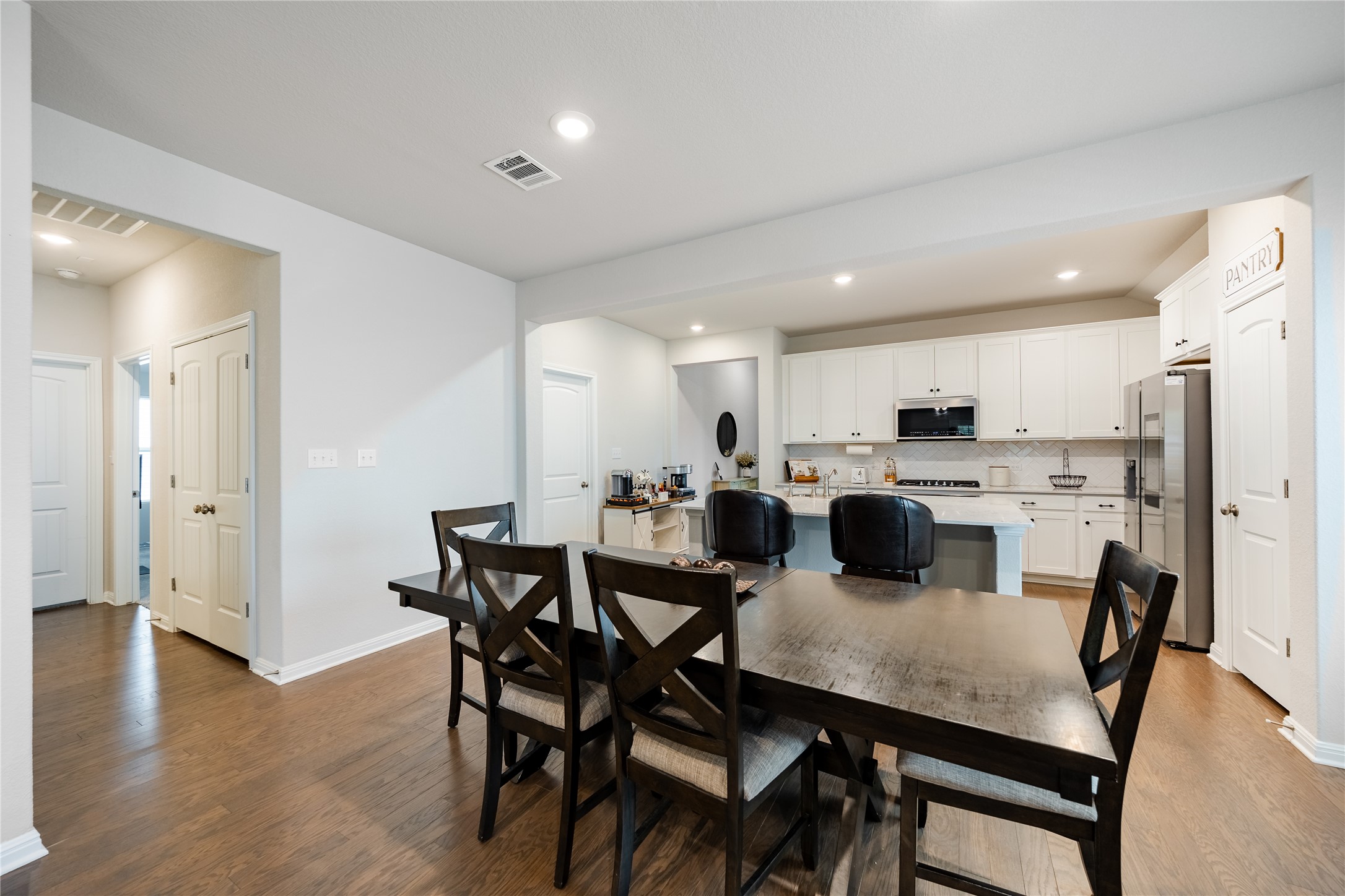 2021 Cartway Court Leander, TX 78641 - Photo 7 of 31 Dining room featuring recessed lighting, visible vents, baseboards, and wood finished floors