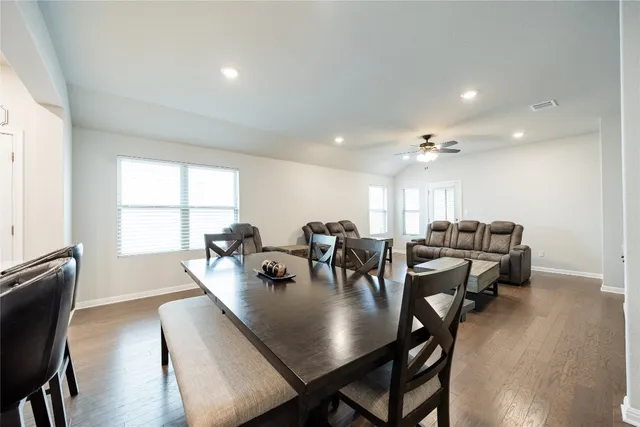 a large kitchen with a table and chairs