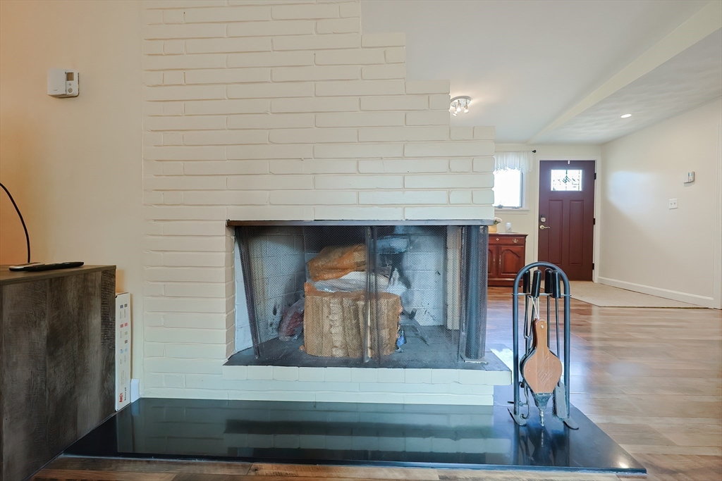 20 Ruth Drive Framingham, MA 01701 - Photo 9 of 42 a hallway with wooden floor and a fireplace