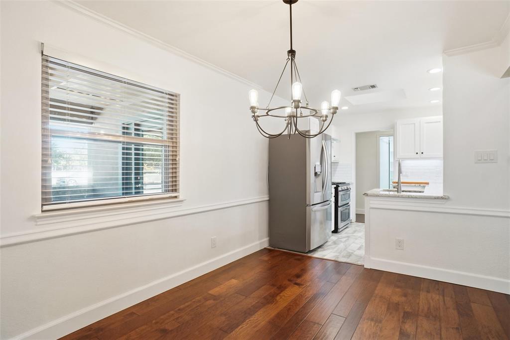 2109 Malone Street Denton, TX 76201 - Photo 11 of 36 a view of a room with wooden floor stove and windows
