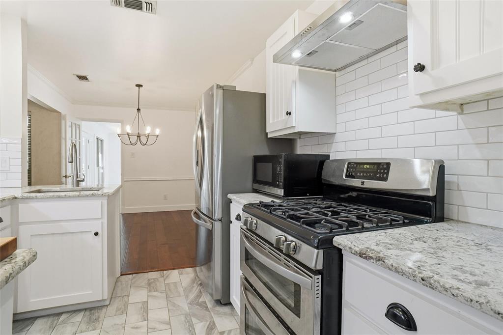 2109 Malone Street Denton, TX 76201 - Photo 12 of 36 a kitchen with a stove and a refrigerator