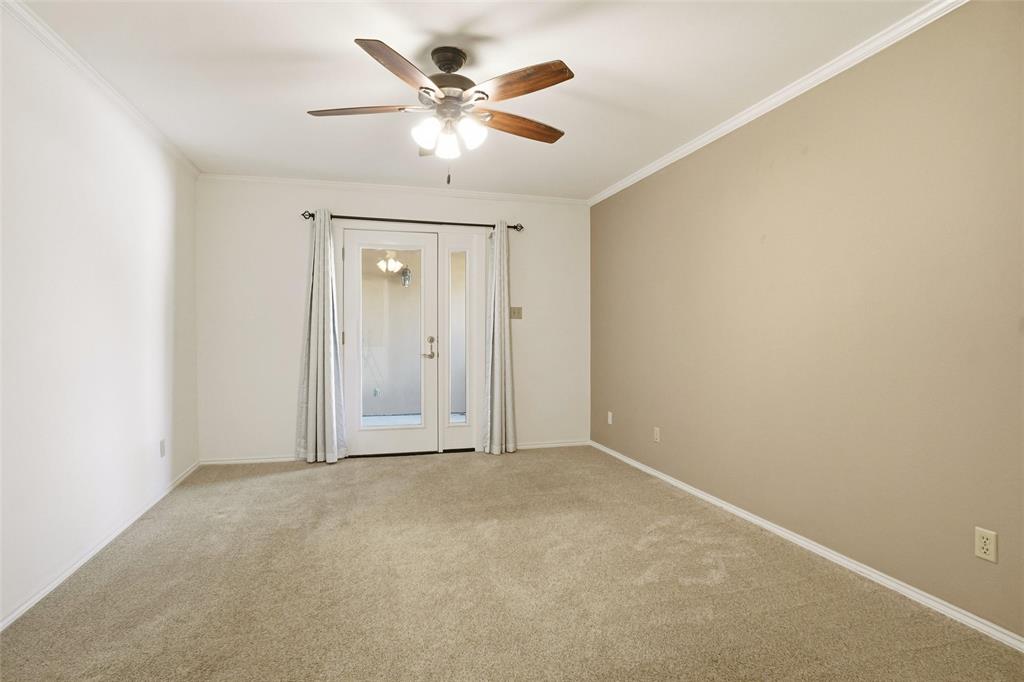 2109 Malone Street Denton, TX 76201 - Photo 13 of 36 an empty room with a chandelier fan and windows