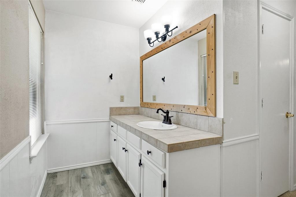 2109 Malone Street Denton, TX 76201 - Photo 15 of 36 a bathroom with a sink and a mirror
