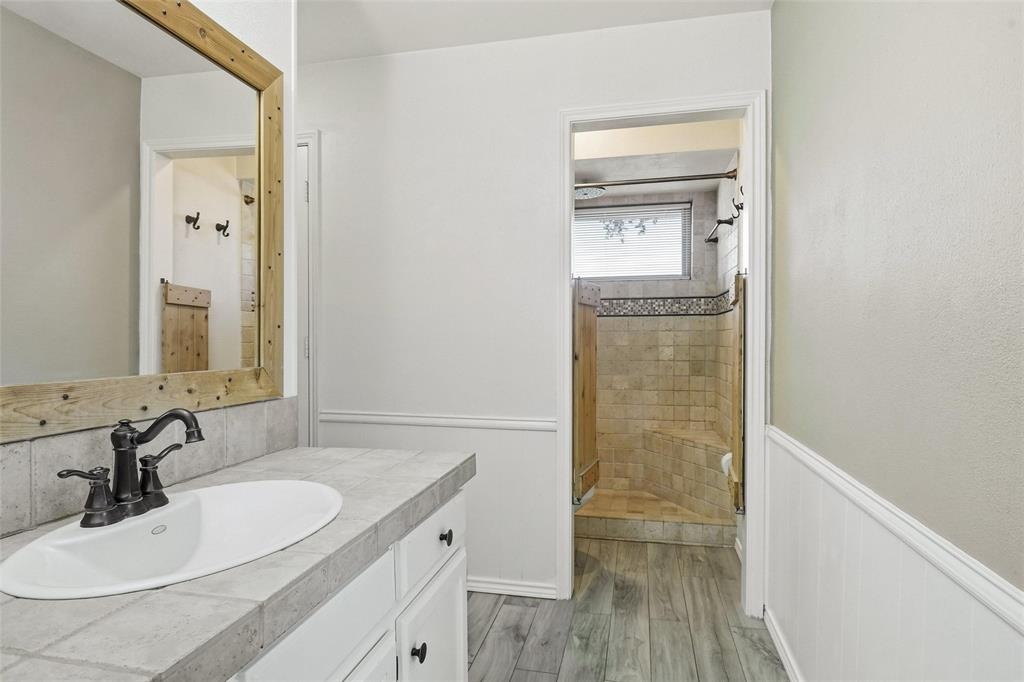 2109 Malone Street Denton, TX 76201 - Photo 16 of 36 a bathroom with a sink a toilet and shower
