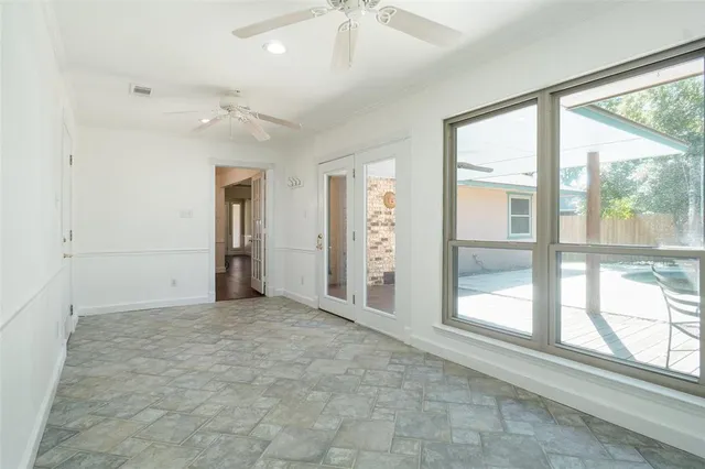 an empty room with windows and closet