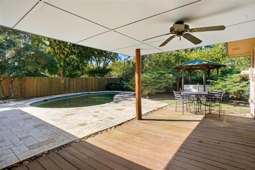 2109 Malone Street Denton, TX 76201 - Photo 25 of 36 a view of a patio with a table chairs potted plants and wooden fence